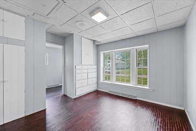 a view of a livingroom with wooden floor and window