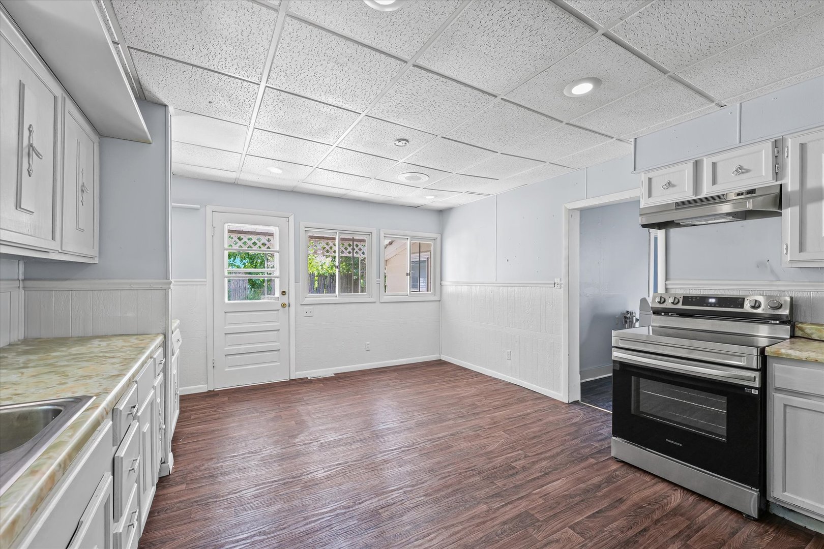 33 State Street Danville, IL 61832 - Photo 9 of 29 a kitchen with a stove wooden floor and a window