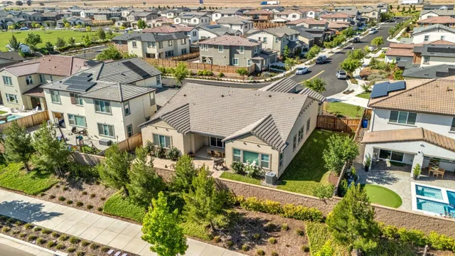 an aerial view of multiple houses with a yard