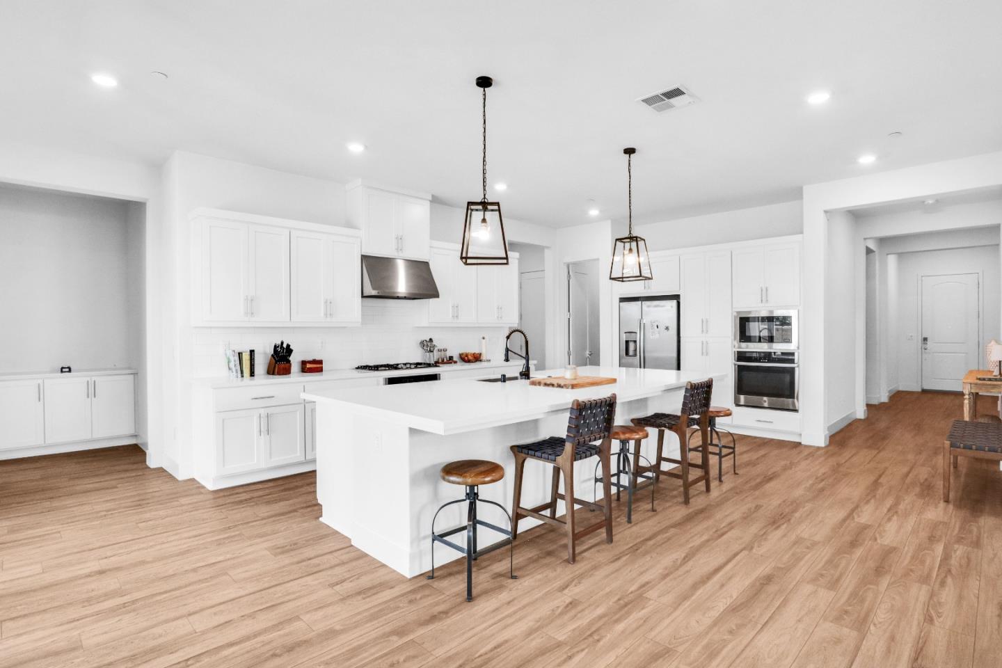 6326 Moser Way Tracy, CA 95377 - Photo 9 of 45 a large white kitchen with lots of counter space and stainless steel appliances