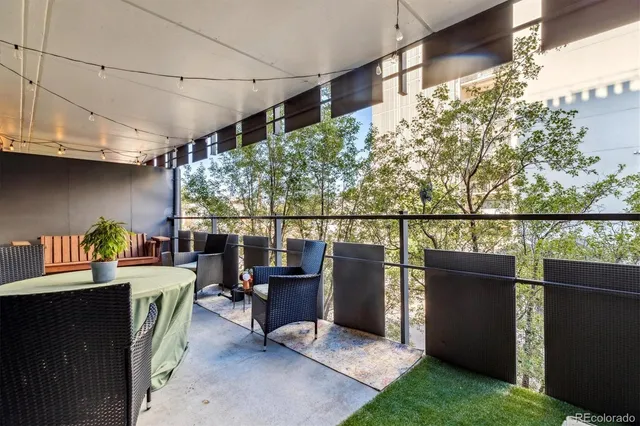 a view of a chairs and table in the back yard of the house