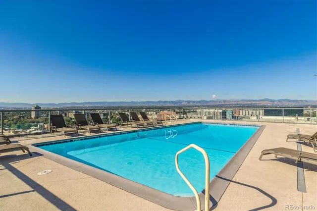 a view of a swimming pool and an outdoor seating
