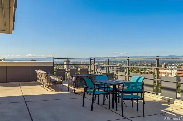 a view of a patio with a table and chairs under an umbrella