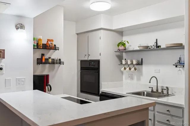a kitchen with sink a stove and refrigerator