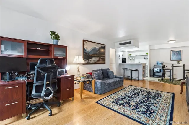 a view of a workspace with furniture and lounge chair