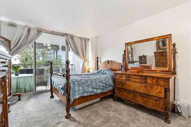 a bedroom with a bed and large mirror