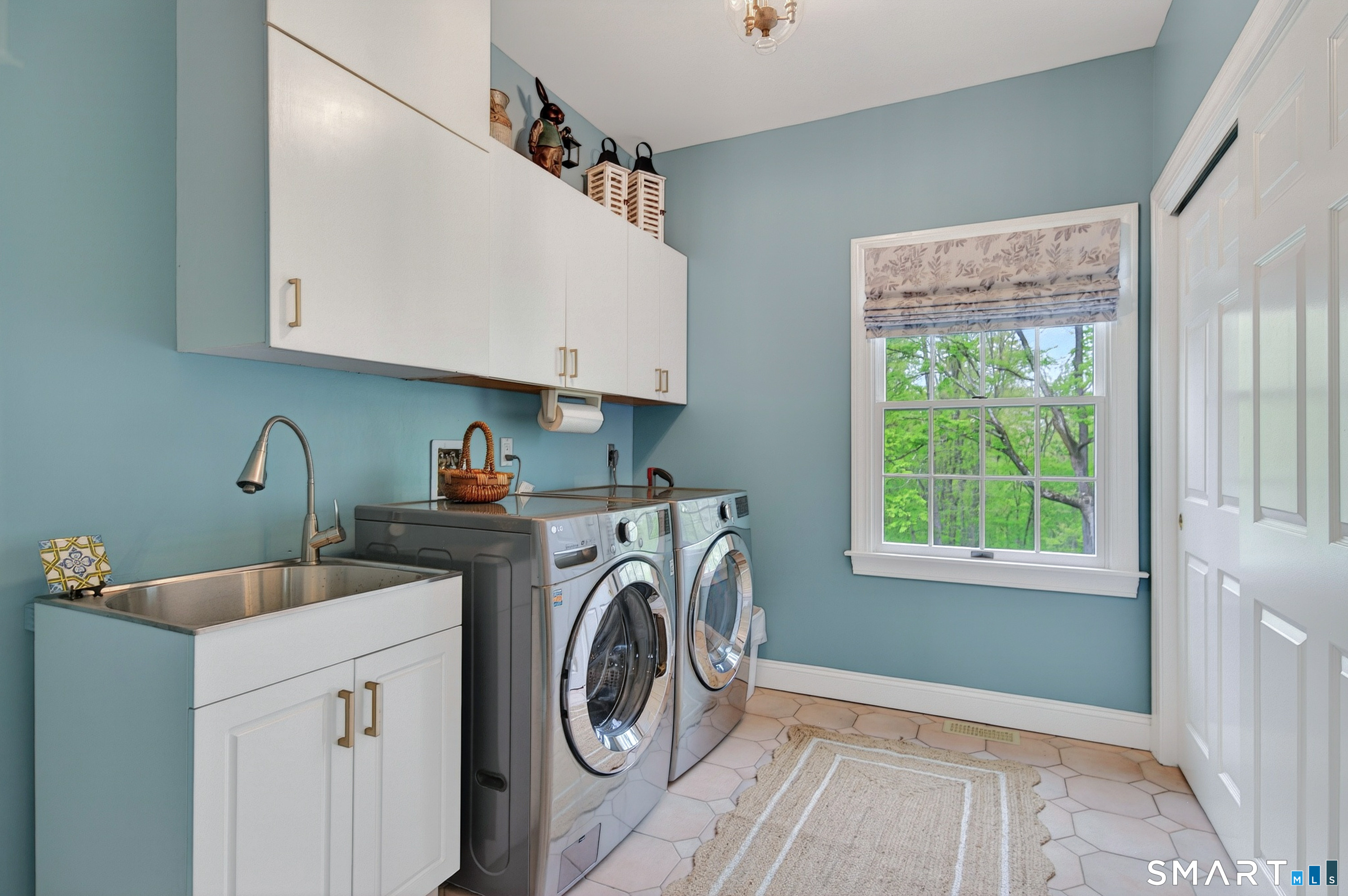 16 Farm Meadow Road Newtown, CT 06470 - Photo 12 of 40 Bright and functional laundry room with custom cabinetry, utility sink, and abundant natural light.