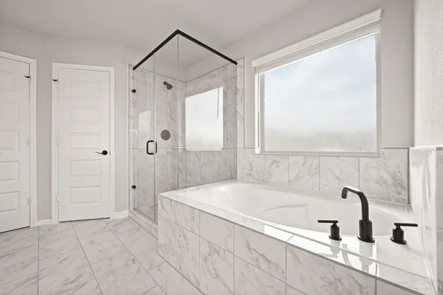 a bathroom with a bathtub and a shower