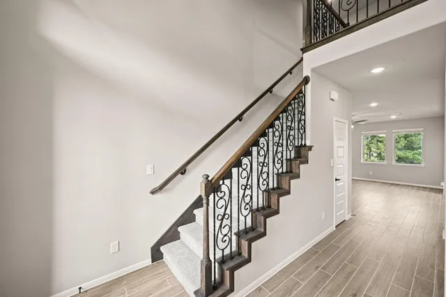 a view of entryway with wooden floor and stairs
