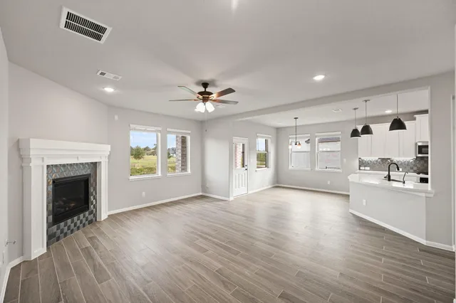 a view of an empty room with a fireplace and a window