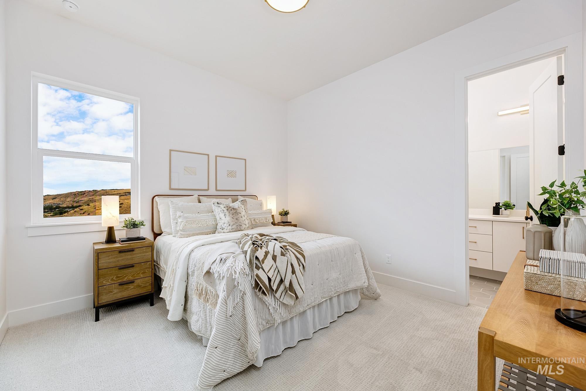 6177 East Prominence Drive Boise, ID 83716 - Photo 36 of 45 Bedroom featuring light carpet and ensuite bathroom