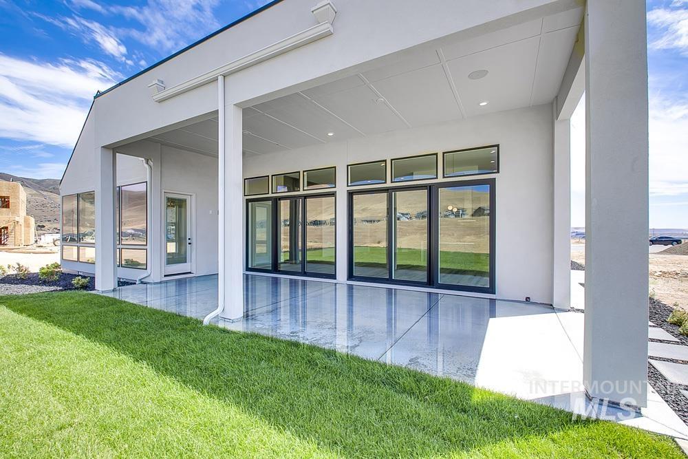 6177 East Prominence Drive Boise, ID 83716 - Photo 37 of 45 Back of property with a patio, stucco siding, and a lawn