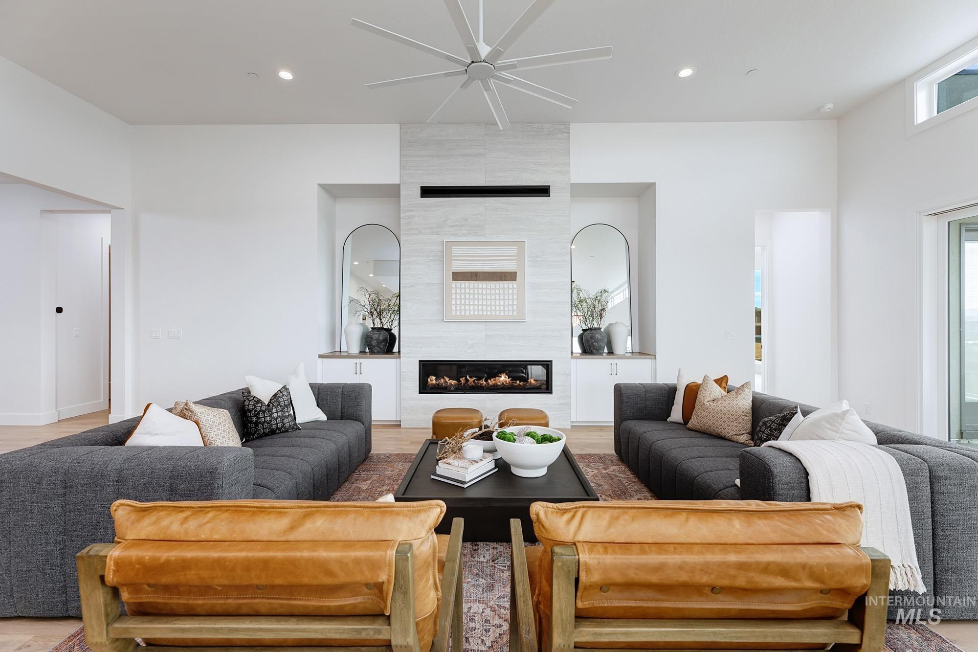 6177 East Prominence Drive Boise, ID 83716 - Photo 6 of 45 Living area with ceiling fan, a tiled fireplace, light wood finished floors, and recessed lighting