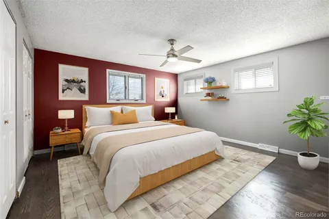 a bedroom with a large bed and a potted plant