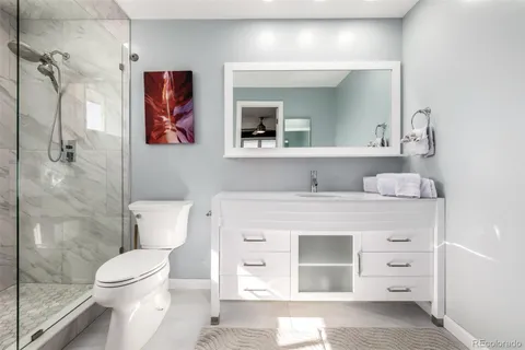 a bathroom with a sink toilet and shower