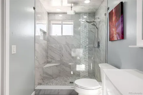 a bathroom with a toilet sink and shower