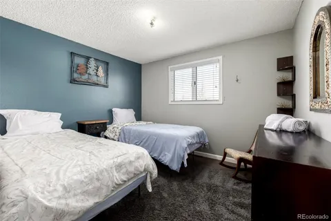 a bedroom with two beds and a desk