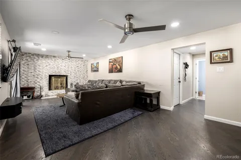 a living room with furniture a fireplace and a flat screen tv