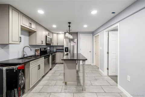a kitchen with stainless steel appliances granite countertop a refrigerator and a sink