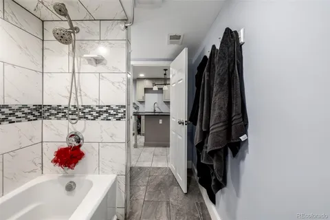 a bathroom with a bathtub and a shower