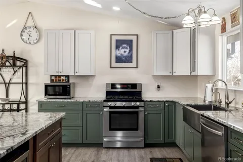 a kitchen with stainless steel appliances granite countertop a stove and a sink