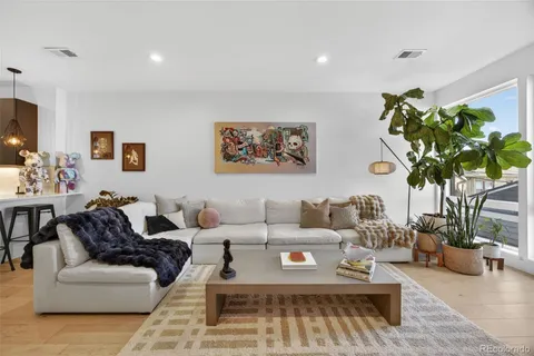 a bedroom with a bed and a painting on the wall