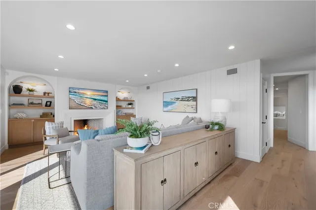 a kitchen with stainless steel appliances a dining table chairs and stove