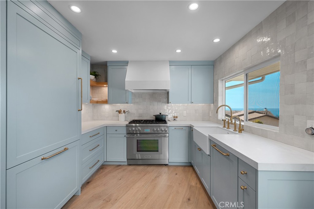 1805 Arriba Linda San Clemente, CA 92672 - Photo 17 of 50 a kitchen with a sink white cabinets and stainless steel appliances