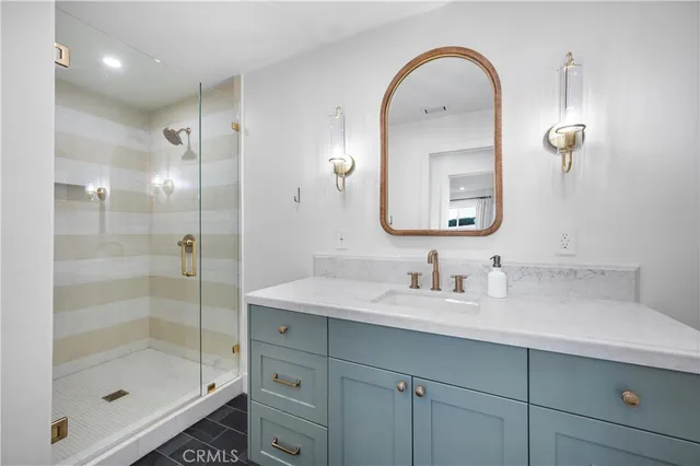 a bathroom with a glass shower door