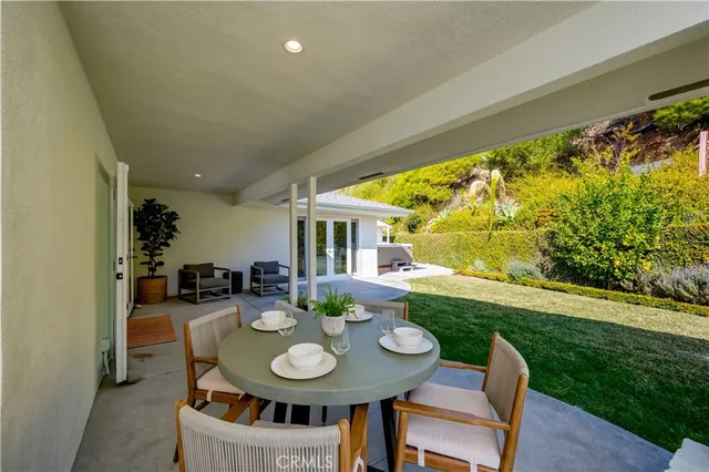a view of a house with swimming pool and furniture