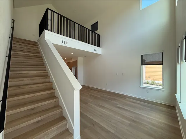 a view of entryway and hall with wooden floor