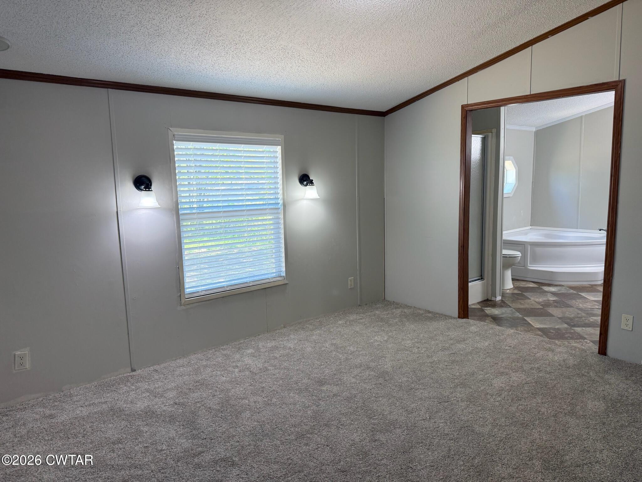 226 Massey Street Adamsville, TN 38310 - Photo 16 of 28 an empty room with windows and entrance