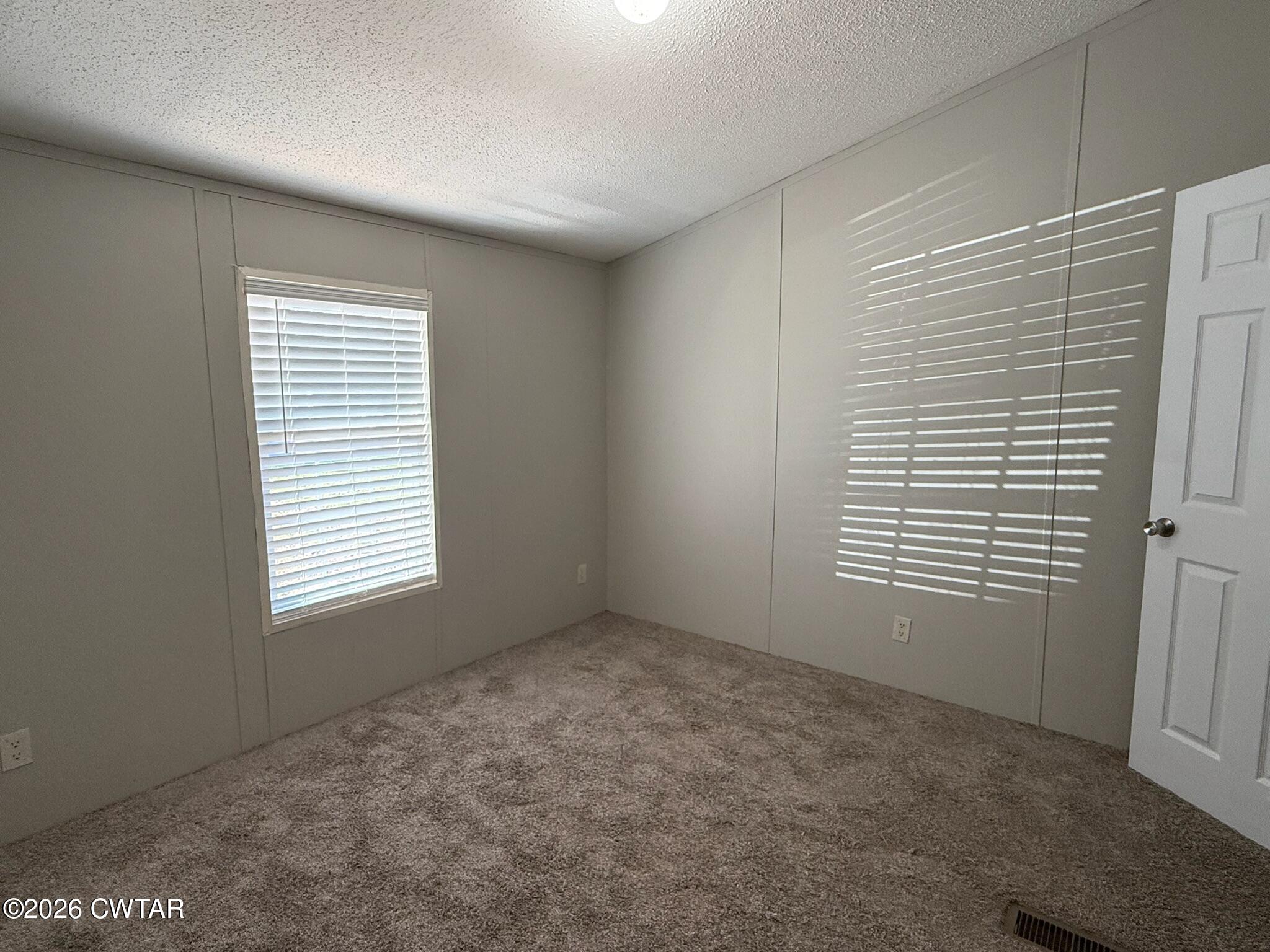 226 Massey Street Adamsville, TN 38310 - Photo 20 of 28 a view of an empty room with a window