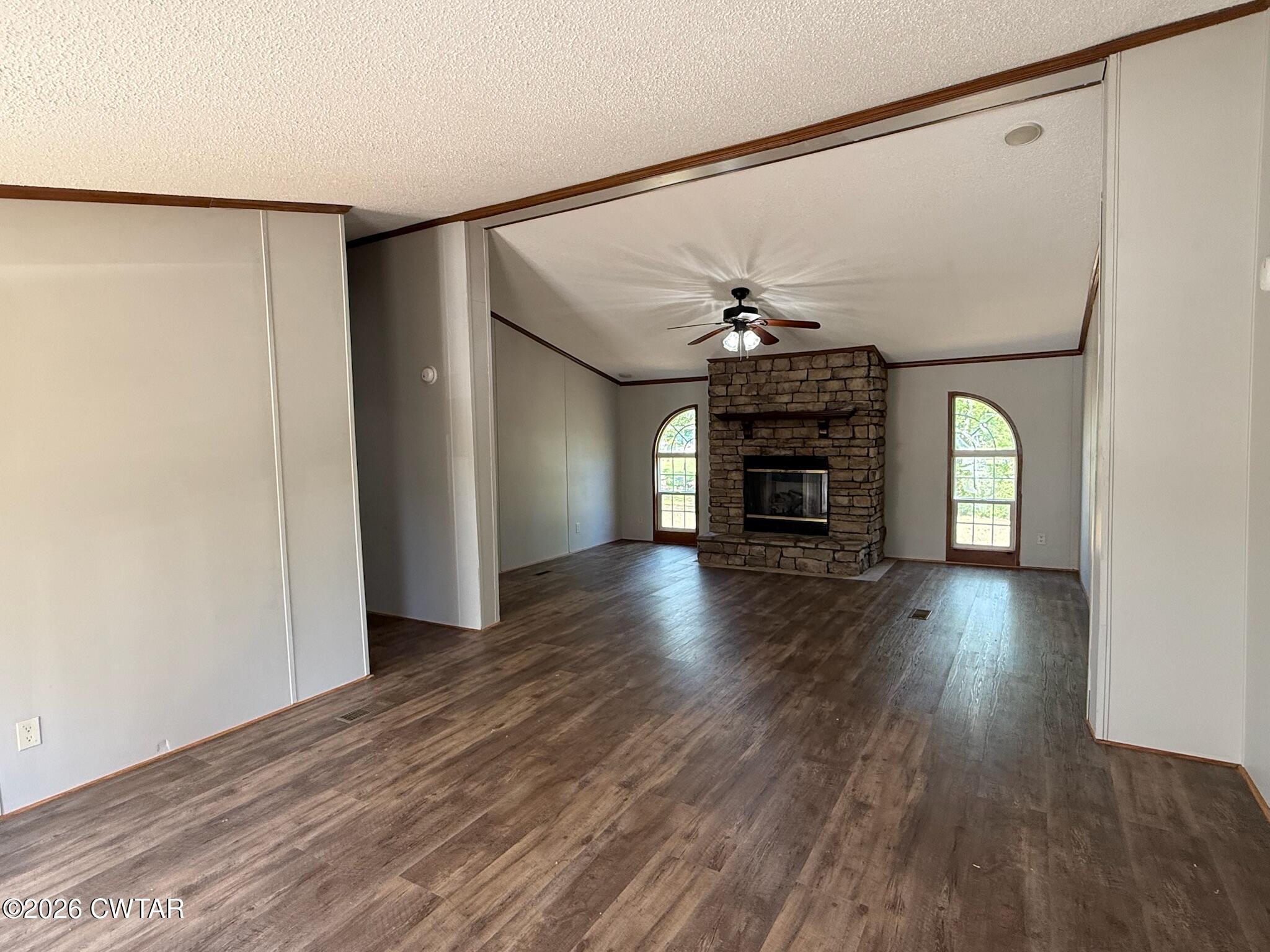 226 Massey Street Adamsville, TN 38310 - Photo 3 of 28 a view of a livingroom with wooden floor staircase and a kitchen space