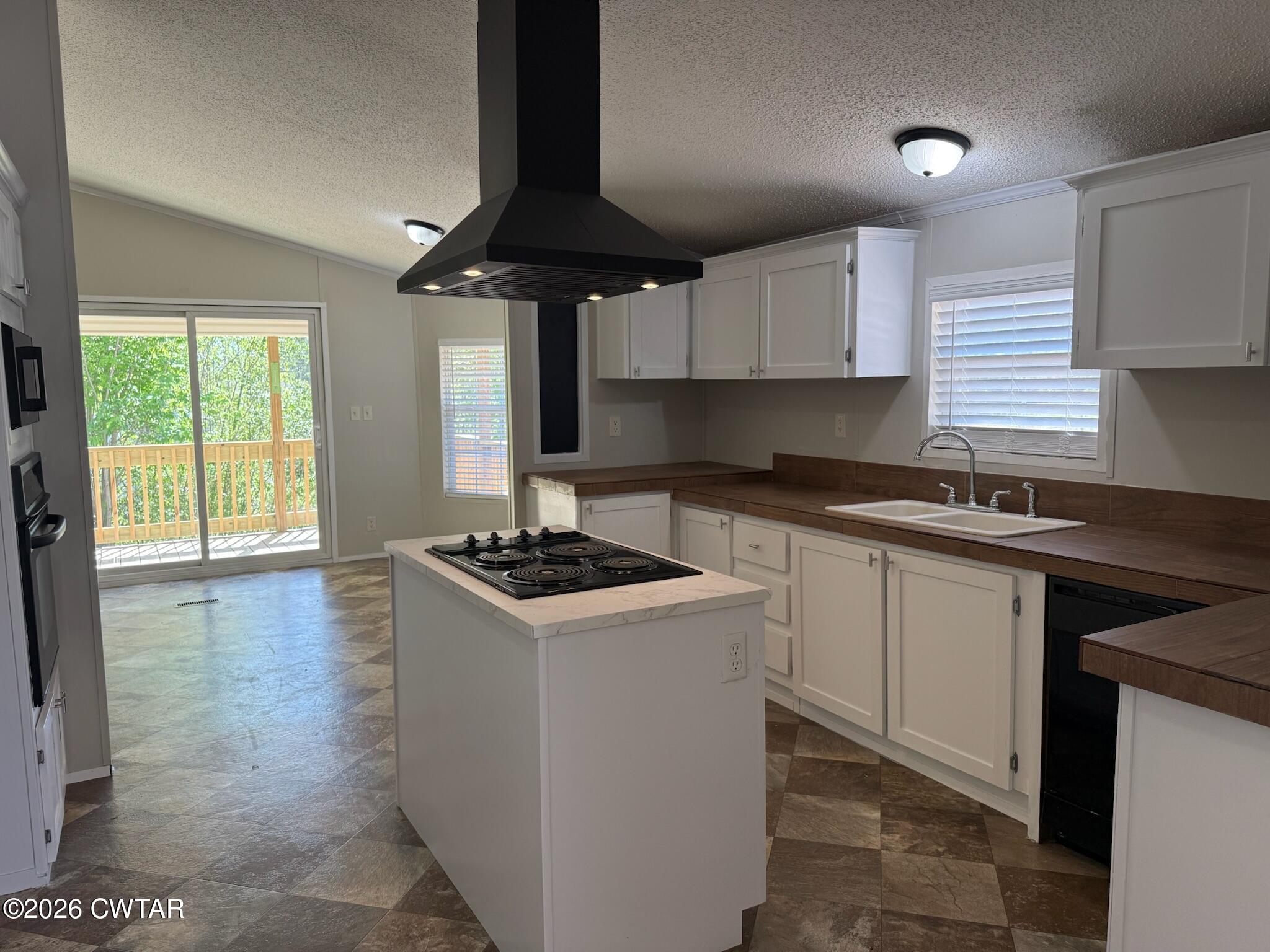 226 Massey Street Adamsville, TN 38310 - Photo 8 of 28 a kitchen with a stove a sink a window and cabinets