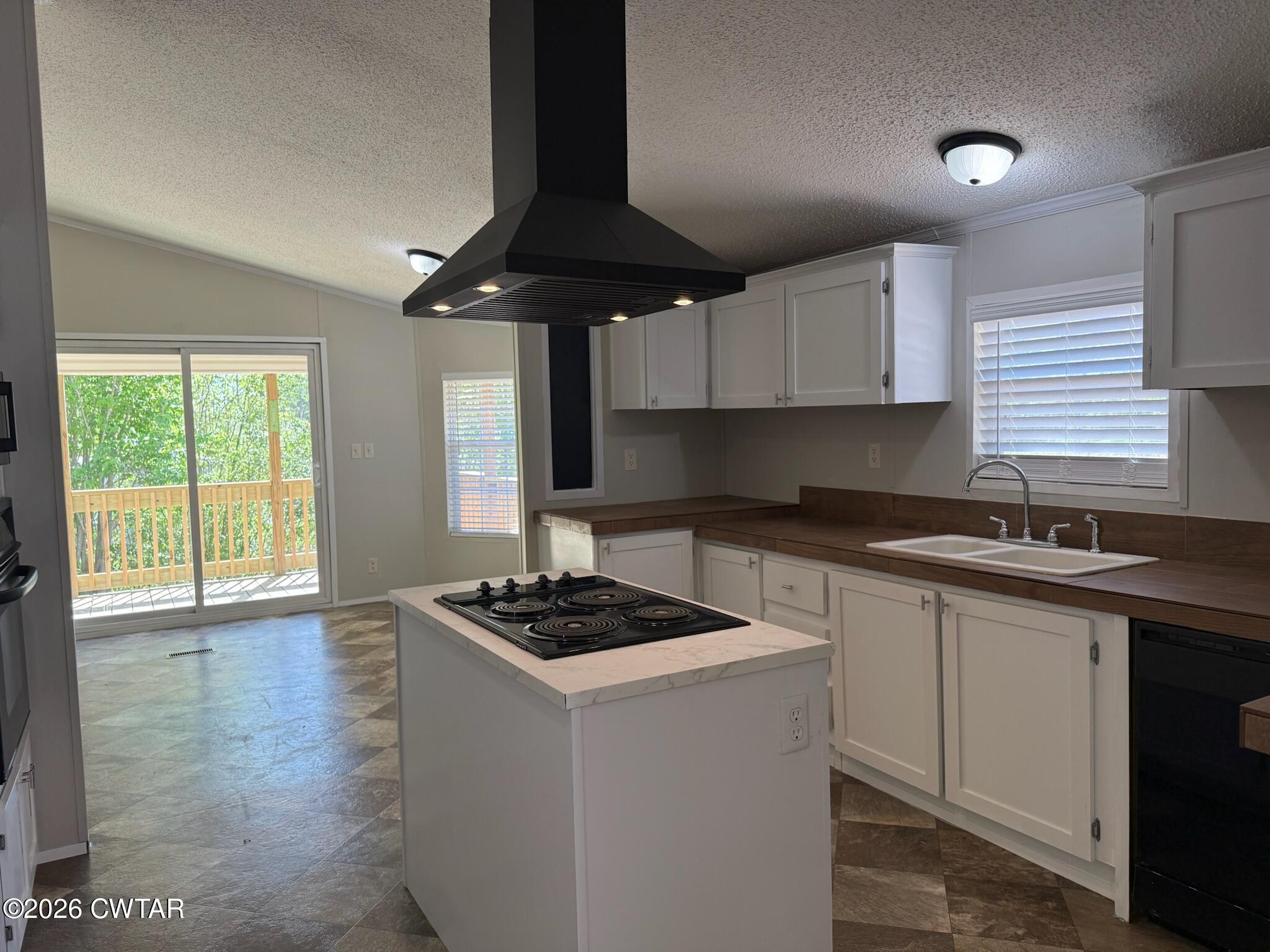 226 Massey Street Adamsville, TN 38310 - Photo 9 of 28 a kitchen with stainless steel appliances granite countertop a sink a stove cabinets and wooden floor