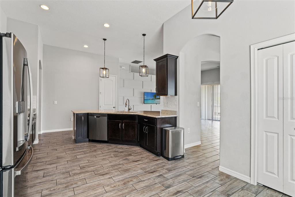 335 Old Windsor Way Spring Hill, FL 34609 - Photo 11 of 41 a large kitchen with stainless steel appliances a refrigerator and a sink