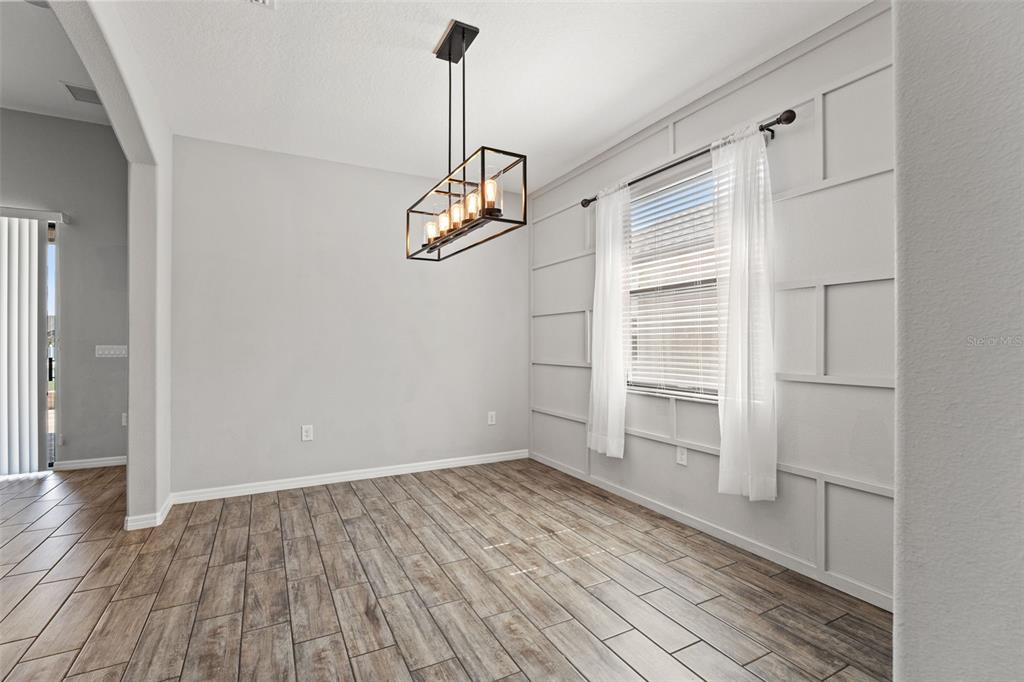 335 Old Windsor Way Spring Hill, FL 34609 - Photo 12 of 41 a view of empty room with wooden floor