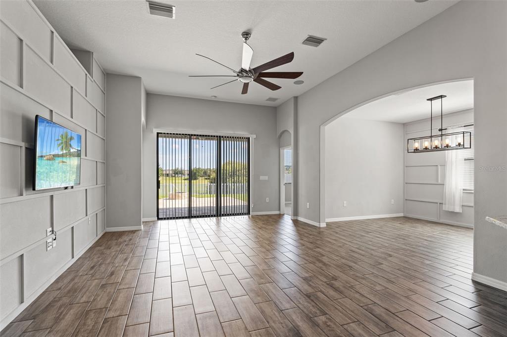 335 Old Windsor Way Spring Hill, FL 34609 - Photo 15 of 41 a view of an empty room with a window and wooden floor