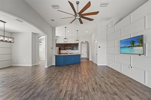 a view of kitchen with wooden floor and electronic appliances