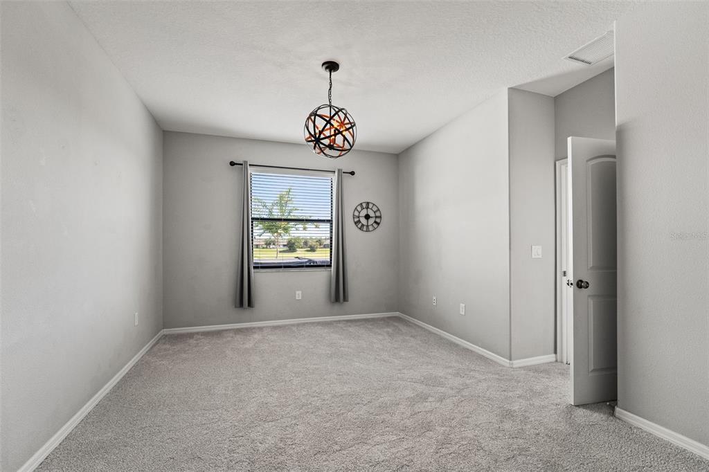 335 Old Windsor Way Spring Hill, FL 34609 - Photo 20 of 41 a view of an empty room with a window and a kitchen