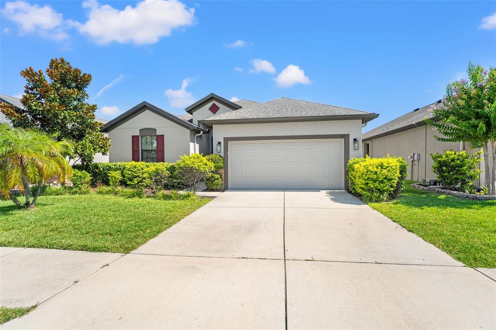 335 Old Windsor Way Spring Hill, FL 34609 - Photo 2 of 41 a front view of a house with a yard and a garage