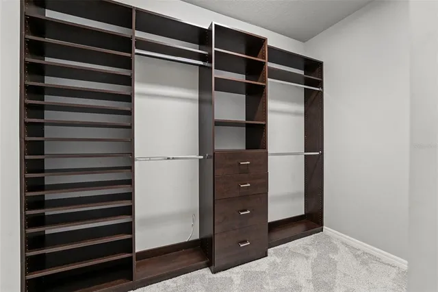 a spacious bathroom with a granite countertop sink a toilet and a mirror