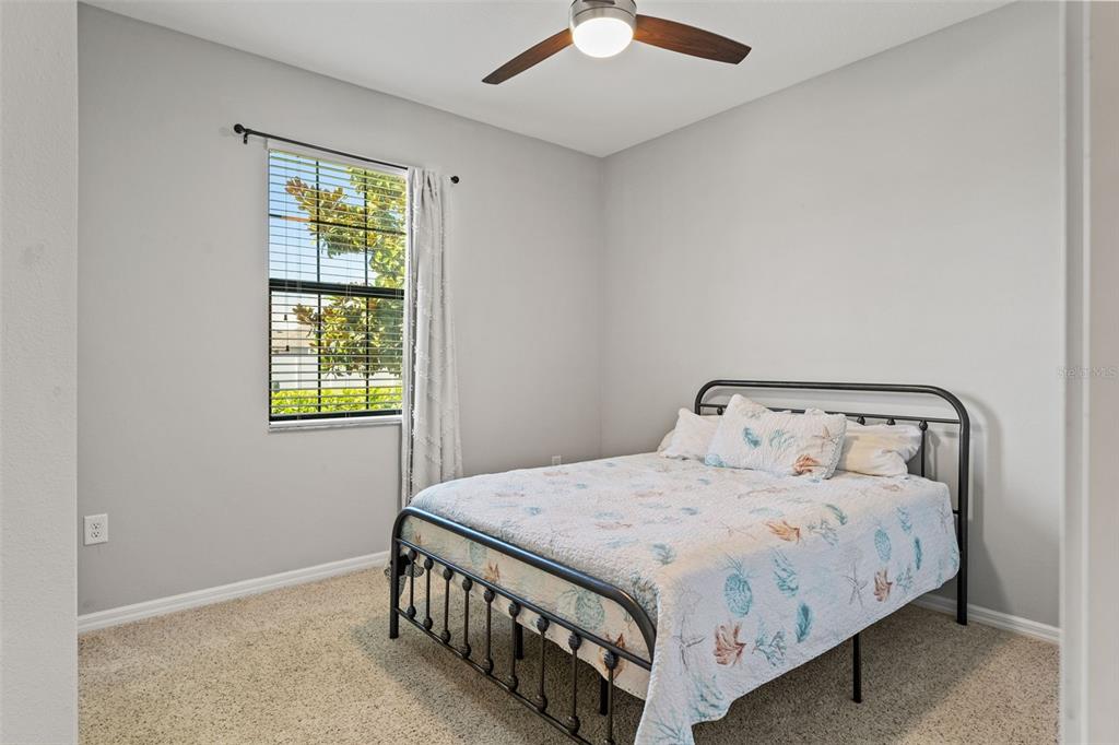 335 Old Windsor Way Spring Hill, FL 34609 - Photo 28 of 41 a bedroom with a bed and a window