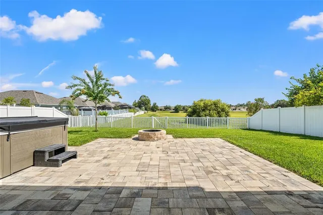 a view of a house with yard and lake view