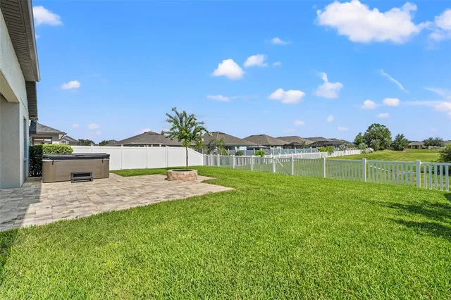 a view of a backyard with swimming pool