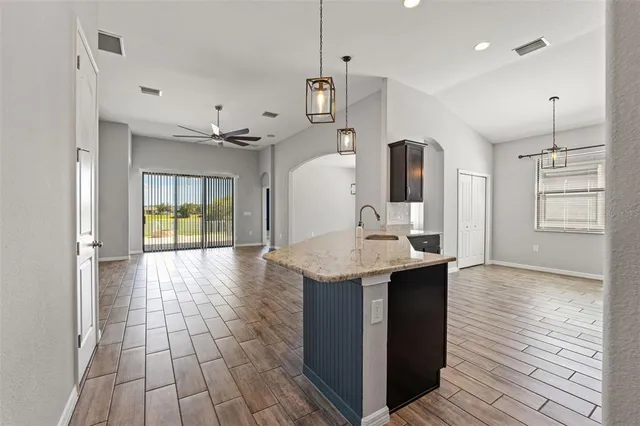 a view of a kitchen with a sink and wooden floor