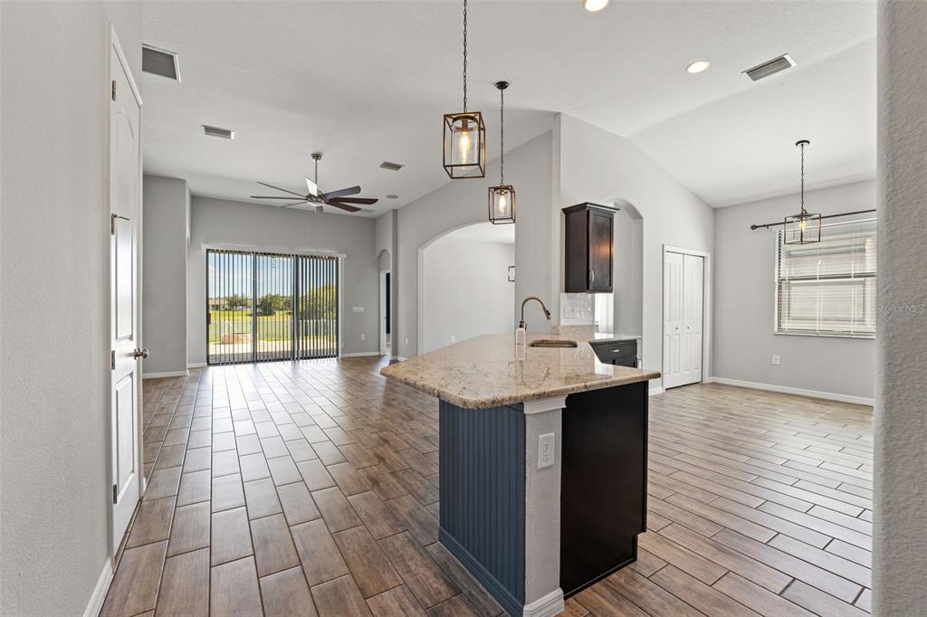 335 Old Windsor Way Spring Hill, FL 34609 - Photo 5 of 41 a view of a kitchen with a sink and wooden floor