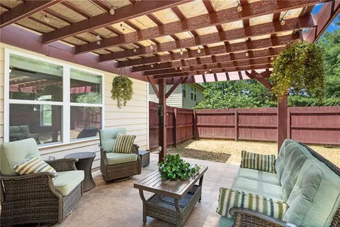 a view of a patio with couches chairs and wooden floor
