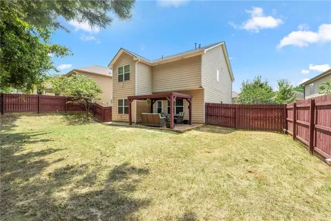 a view of a house with swimming pool and a yard